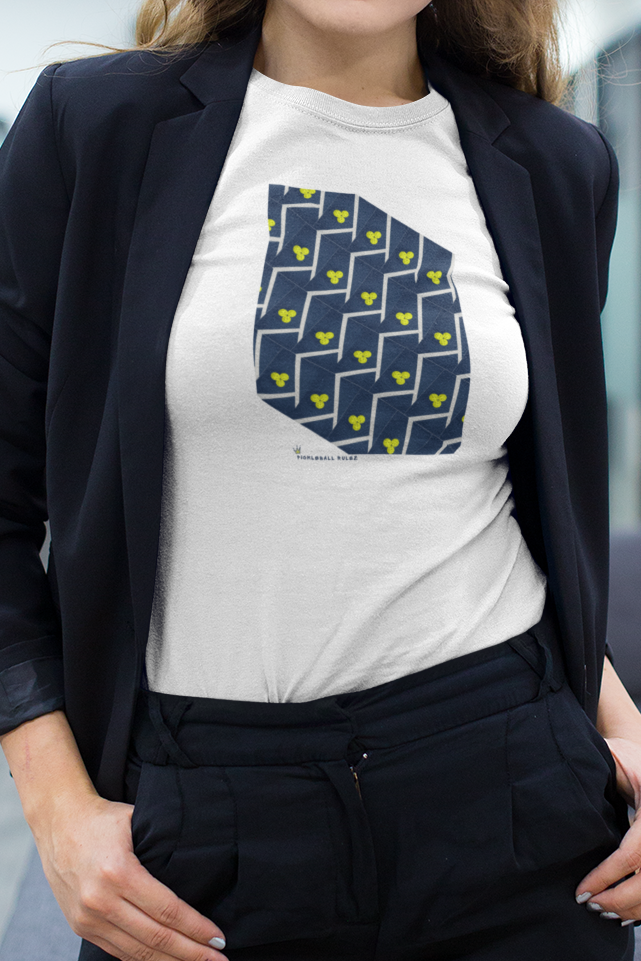 Woman standing in an office setting wearing a white t-shirt with a blue graphic design.