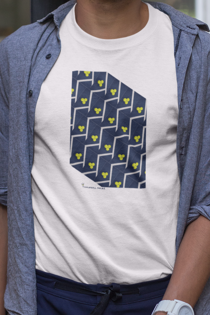 Man wearing a white t-shirt with a blue geometric design, blue shirt, and dark pants outdoors.