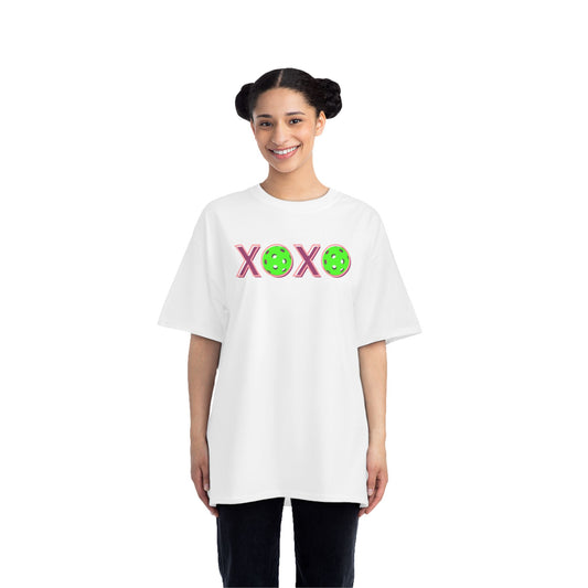 Person wearing a white t-shirt with colorful designs on a white background