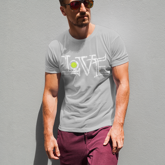 Man wearing a gray t-shirt with a graphic design standing against a gray wall.