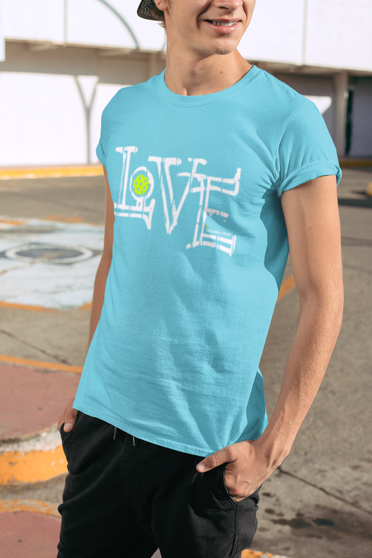 Person wearing a light blue t-shirt with 'LOVE' printed on it, standing outdoors.