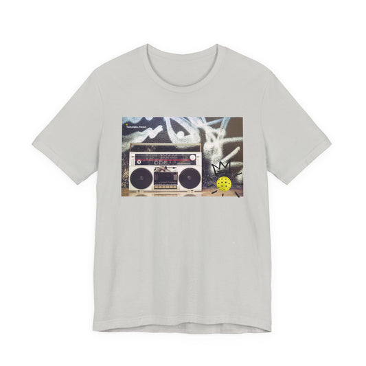 Gray t-shirt with a graphic of a boombox and cassette tape on a white background