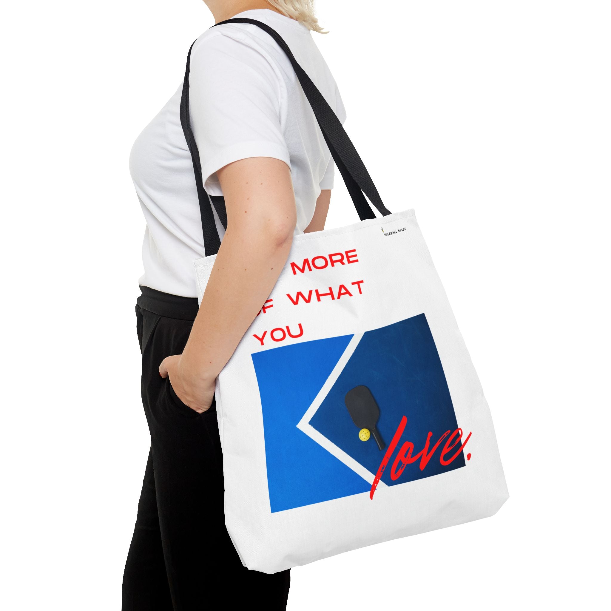 Person holding a tote bag with a design and text on a white background