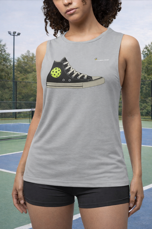 Person wearing a tank top with a graphic of a sneaker and pickleball ball on a tennis court background