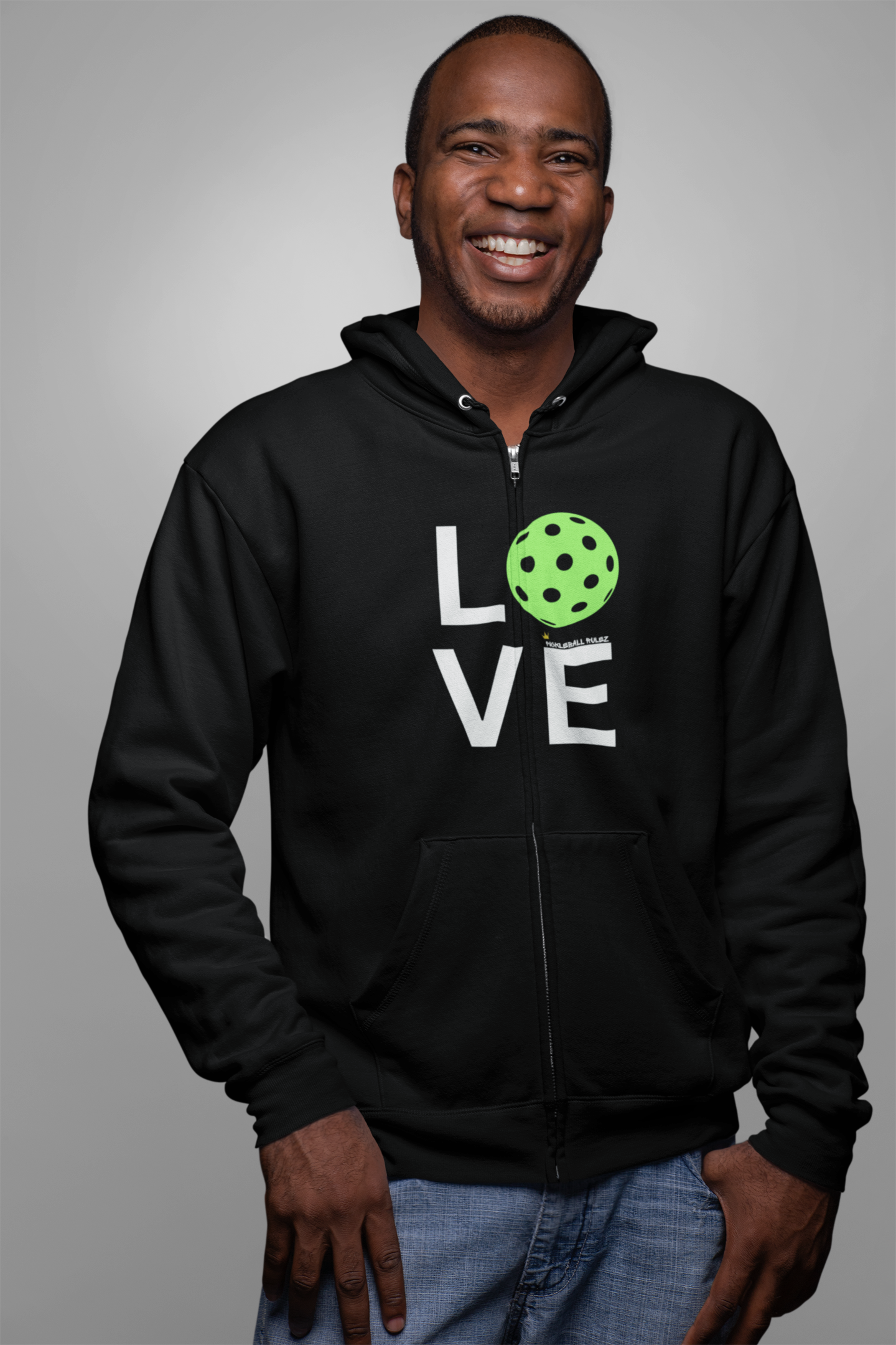 Man wearing a black hoodie with 'LOVE' and a pickleball design on a gray background