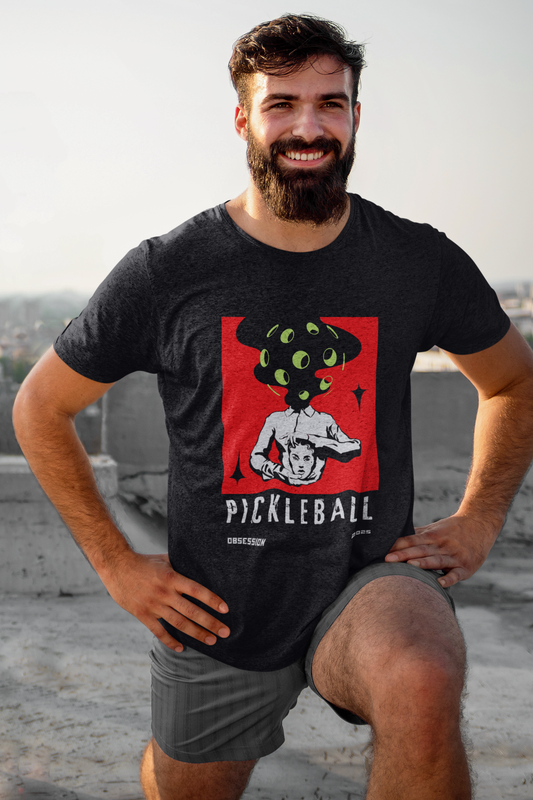 Man wearing a black t-shirt with a pickleball graphic design on a rooftop.