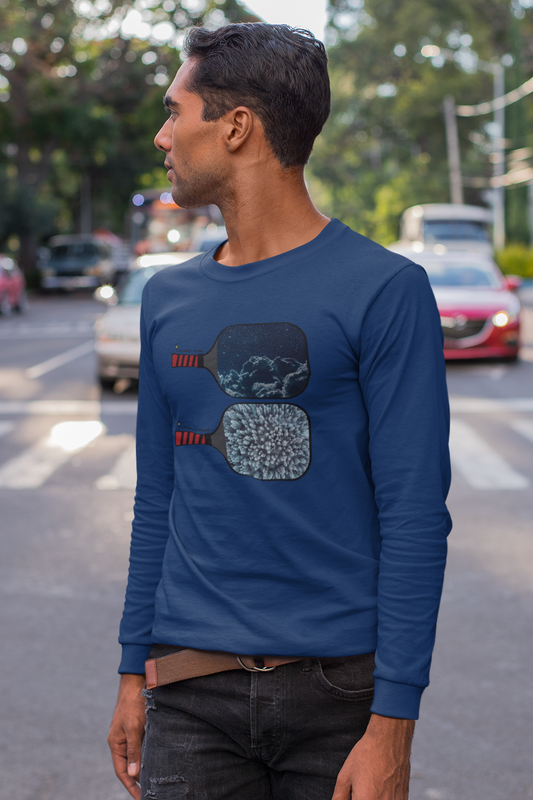 Man wearing a blue long-sleeve shirt with a graphic design on a street.