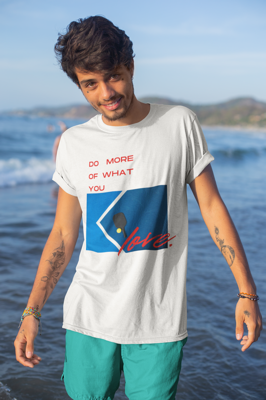 Man wearing a white t-shirt with a graphic design on a beach