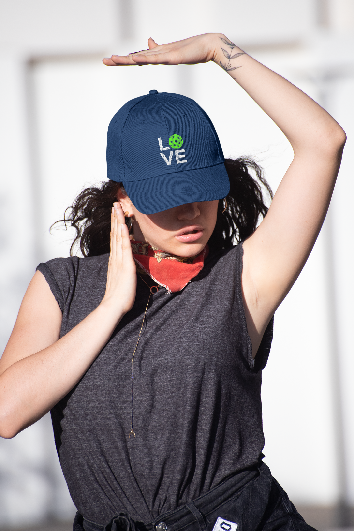 Person wearing a navy blue cap with 'LOVE' printed on it, standing against a light background.
