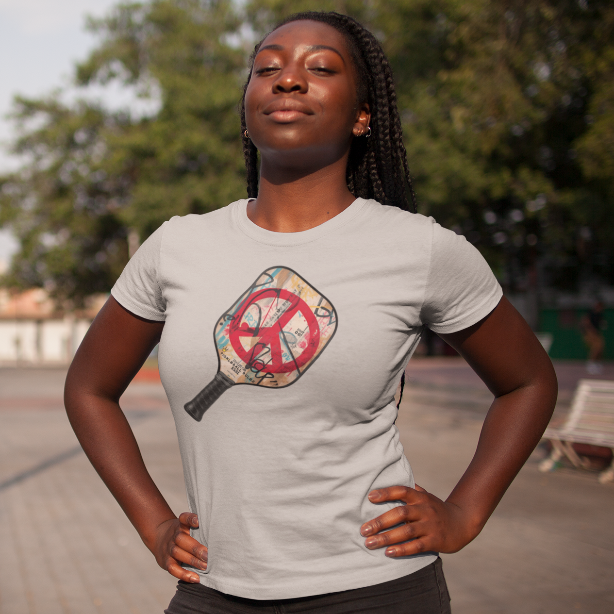Woman wearing a t-shirt with a graphic design on a street background