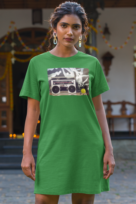 Woman wearing a green dress with a graphic design in front of a traditional building.