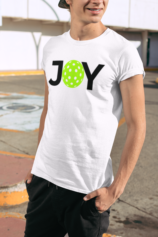 Person wearing a white t-shirt with 'JOY' printed on it, standing outdoors.
