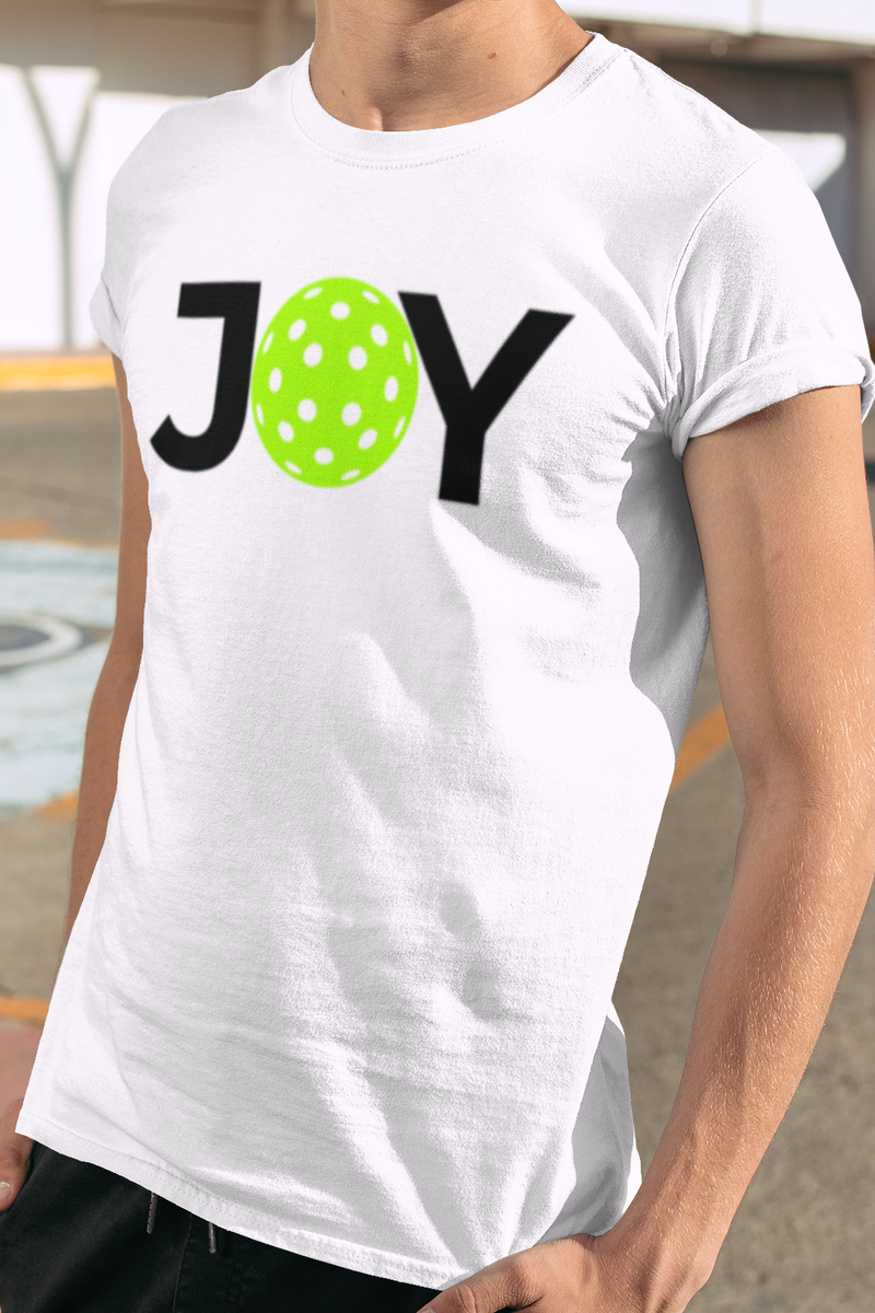 Person wearing a white t-shirt with 'JOY' printed on it, standing outdoors.