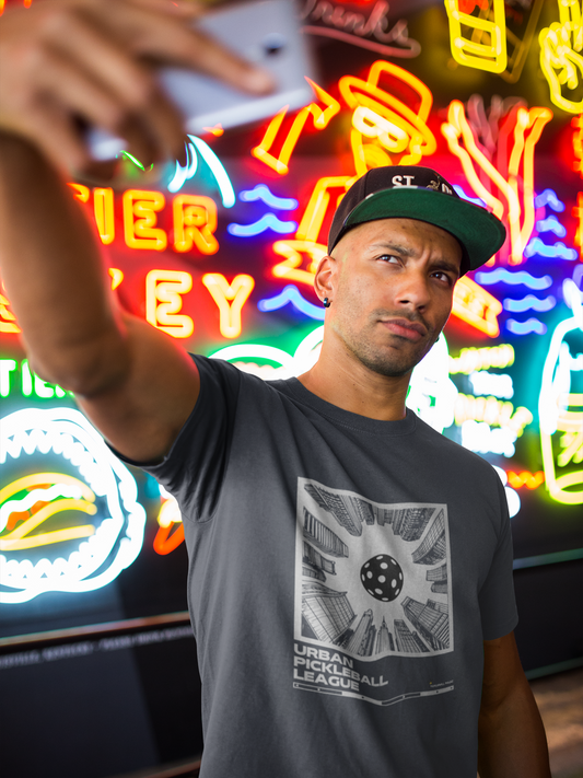 Man taking a selfie in front of neon signs