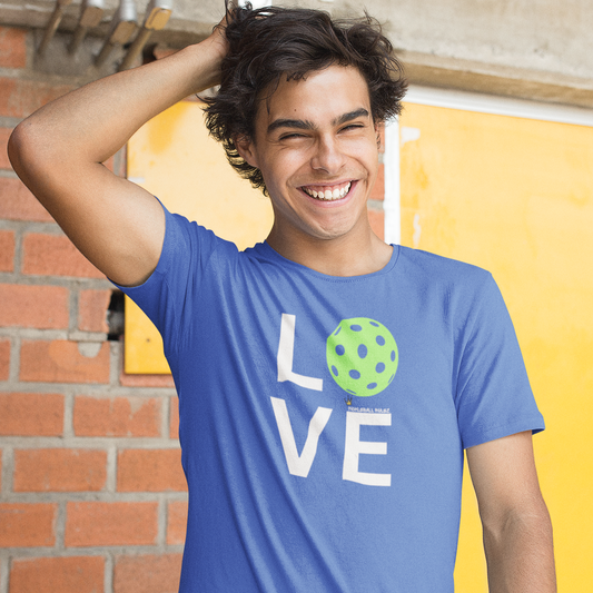 Person wearing a blue t-shirt with 'LOVE' printed on it, standing against a yellow wall.