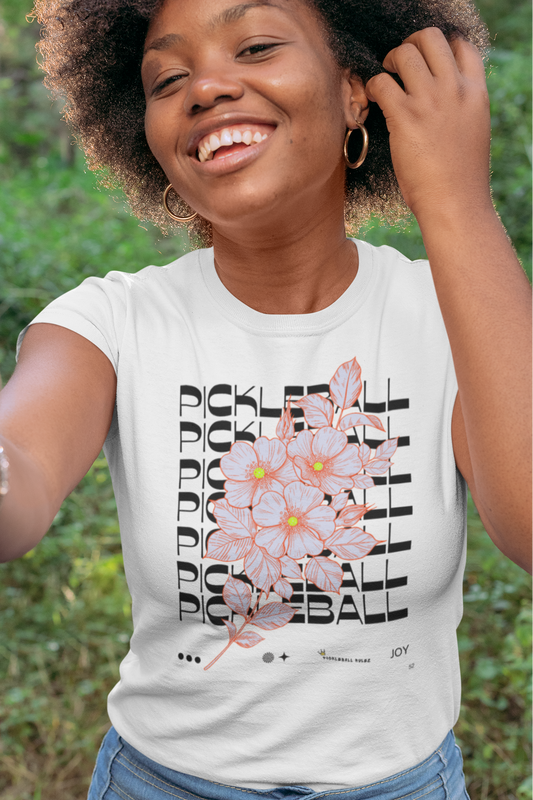 Woman wearing a white t-shirt with a graphic design outdoors